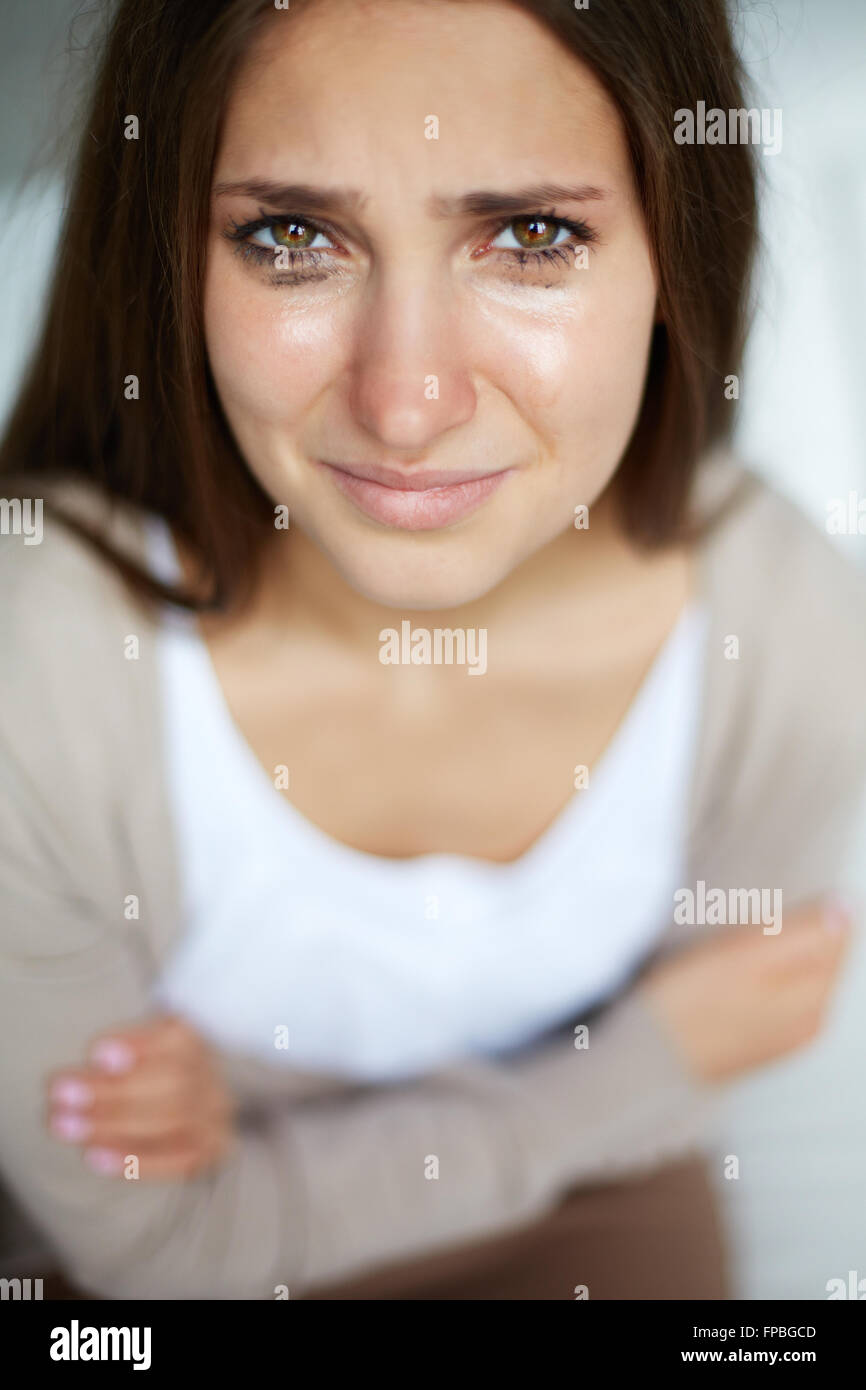 Young woman crying and looking at camera Stock Photo