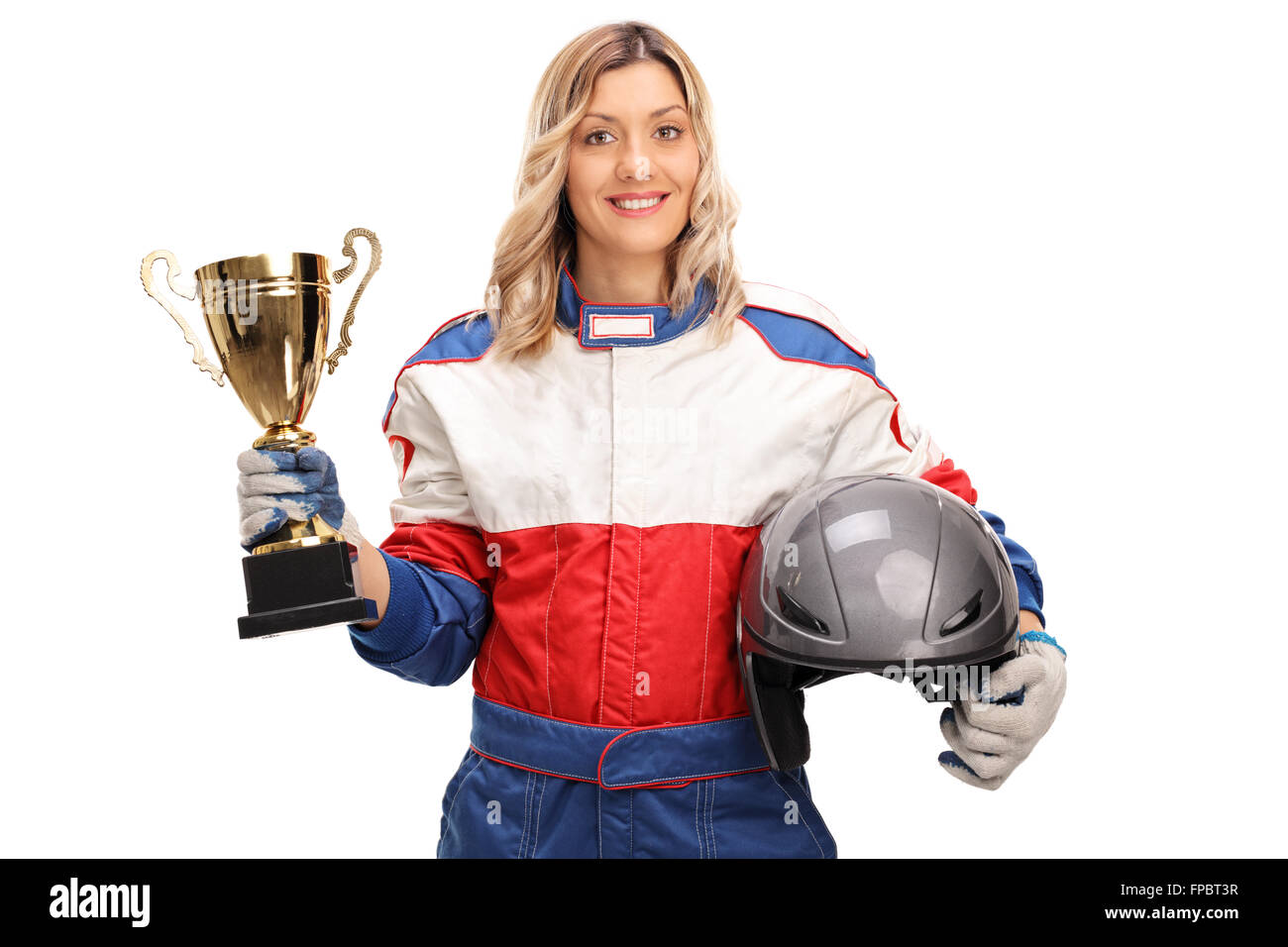 Young female car racing champion holding a gold trophy and looking at the camera isolated on white background Stock Photo