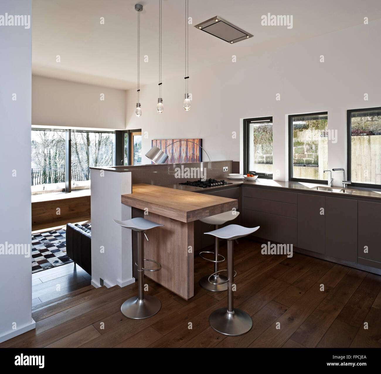 The open plan kitchen and living area of a luxury flat in Ledcamernoch House Glasgow, including and showing how well light from windows has been used. Stock Photo