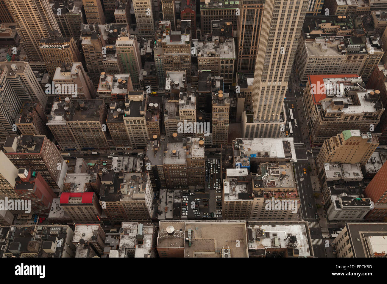 A look down onto skyscrapers and high rises densely packed together on Manhattan streets from the top of the Empire State Building. Stock Photo