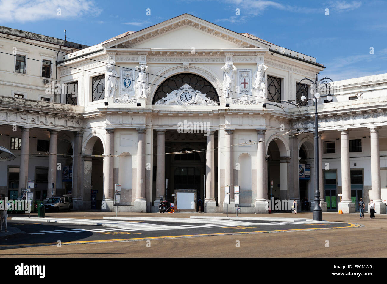 An exterior view of Piazza Principe railway station in Genoa. Designed by Alexander Mazzucchetti. People walking on the street. Stock Photo