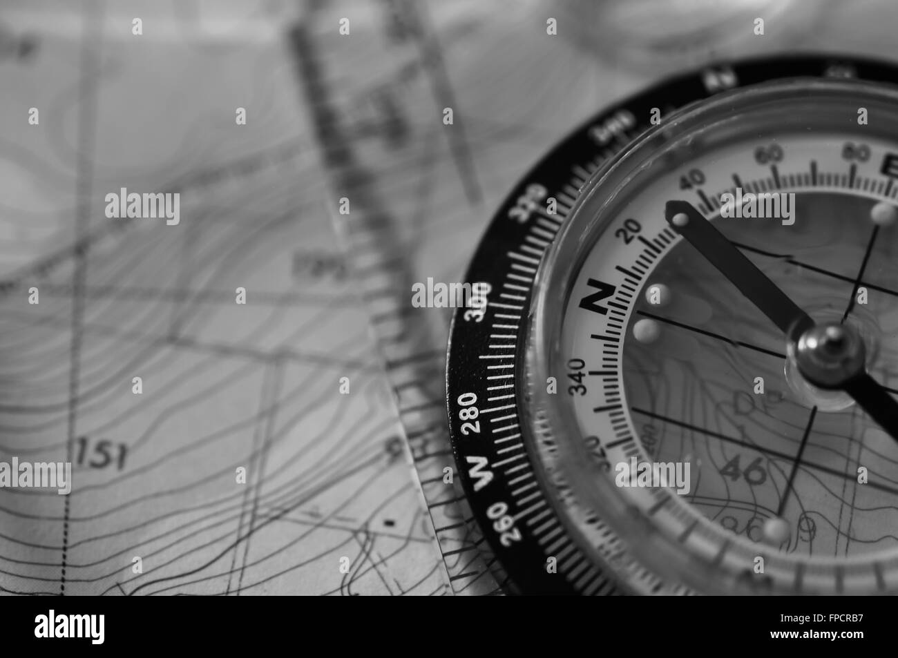 Compass Sitting on a Map in Black and Whte Stock Photo