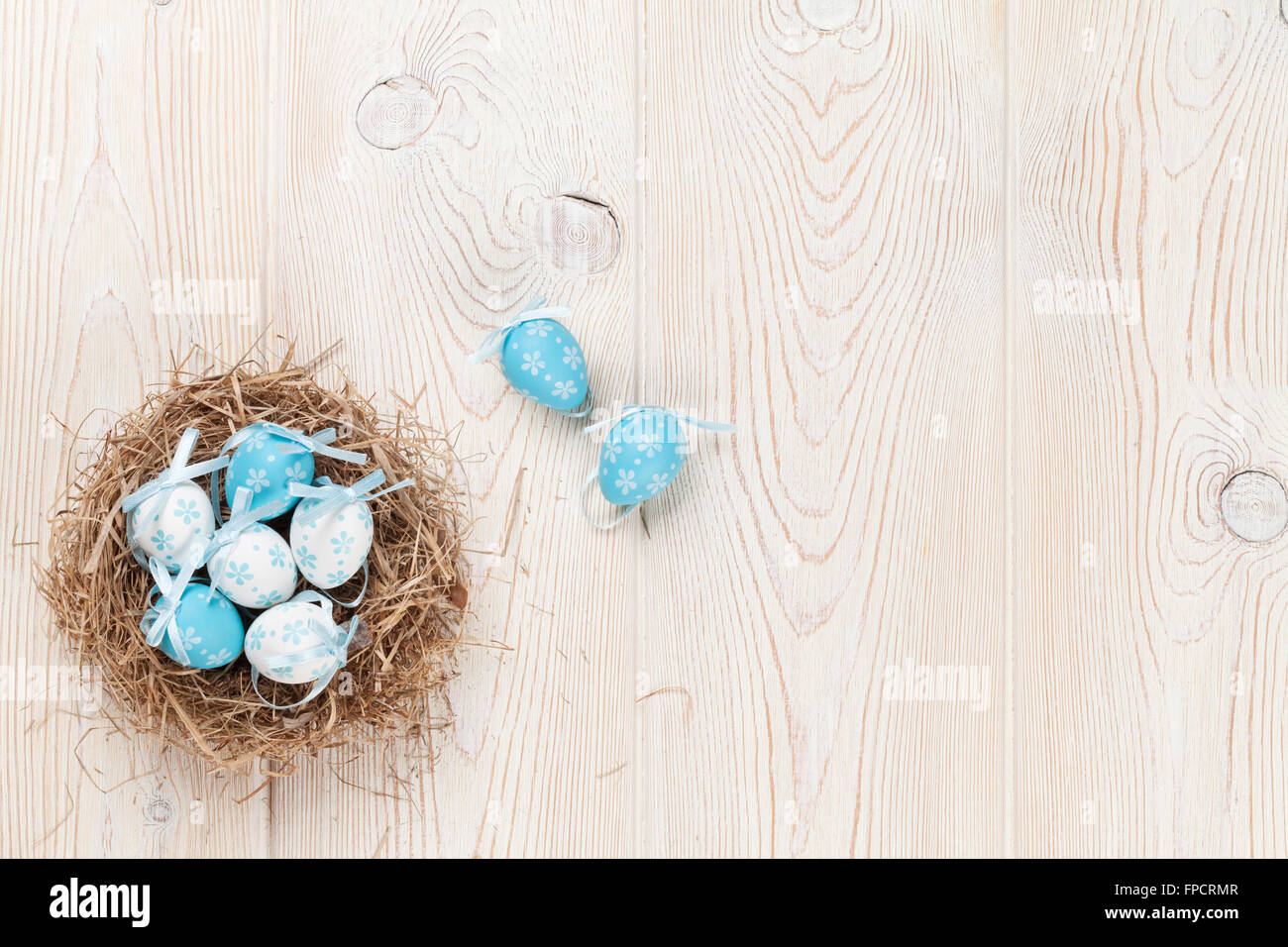 Easter eggs in nest over wooden background. View with copy space Stock ...