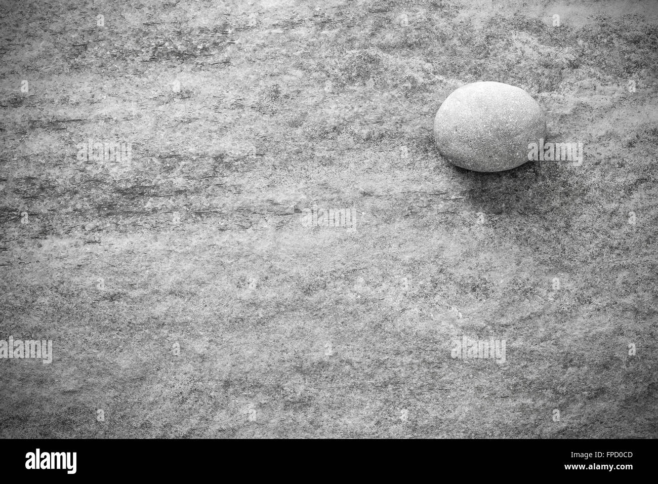 Black and white stone on rock, grunge background or texture. Stock Photo