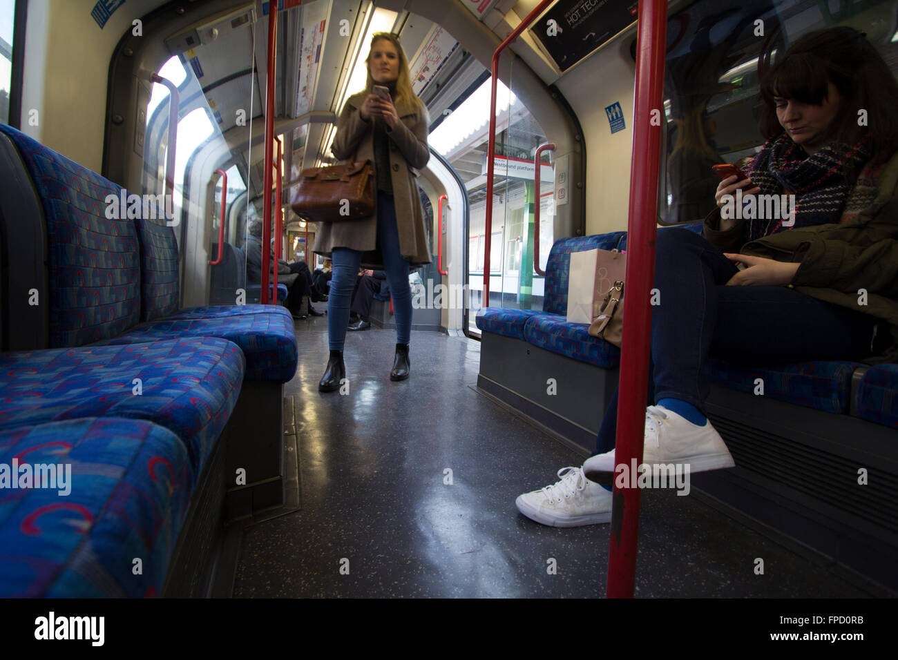 using mobile phone on London Underground tube network train, Central