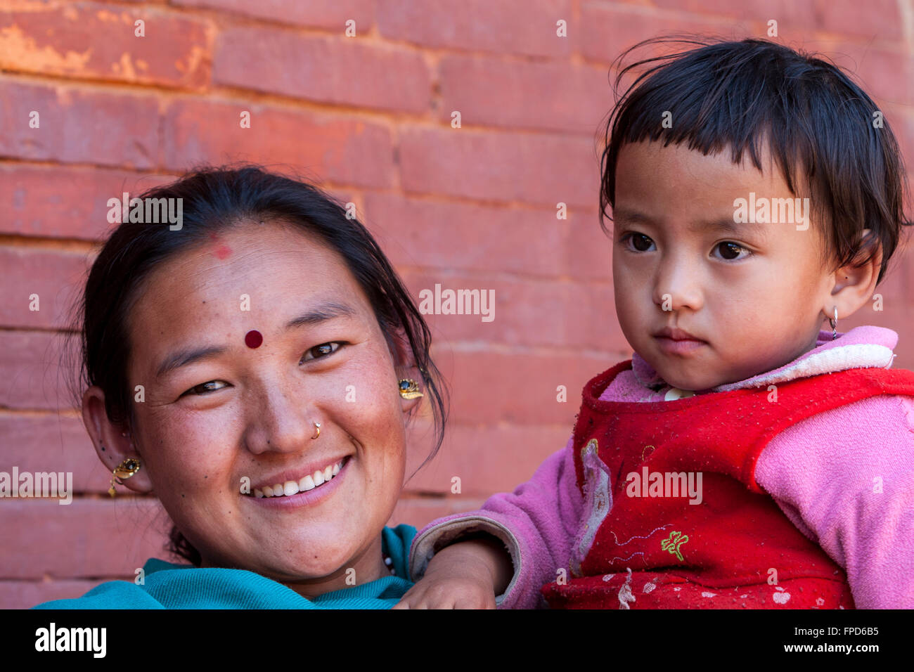 Nepal, Patan.  Nepali Mother and Daughter.  The mother wears a bindi between her eyes, and a nose-ring. Stock Photo