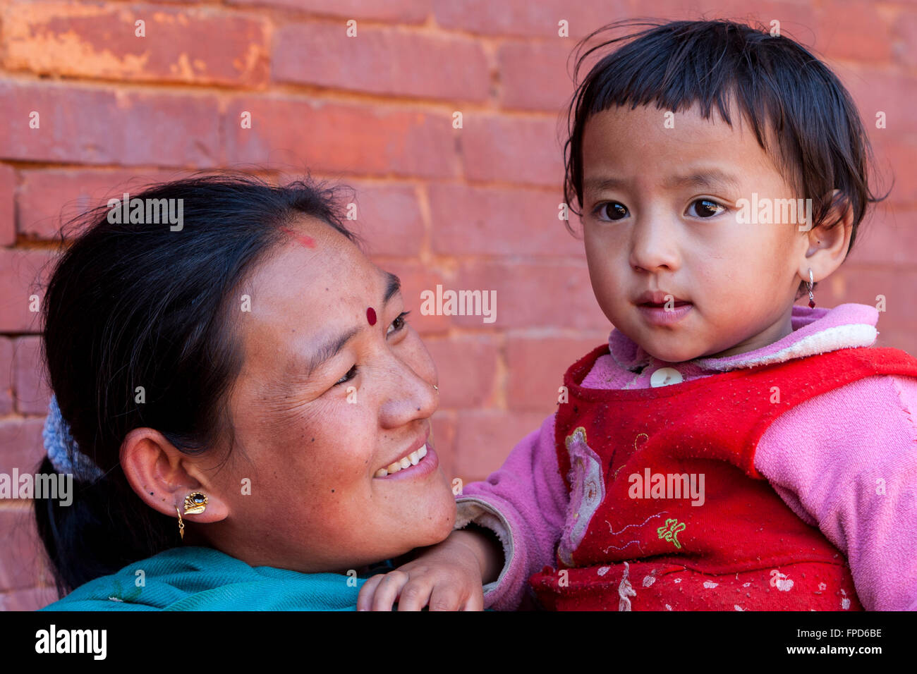 Nepal, Patan.  Nepali Mother and Daughter.  The mother wears a bindi between her eyes, and a nose-ring. Stock Photo