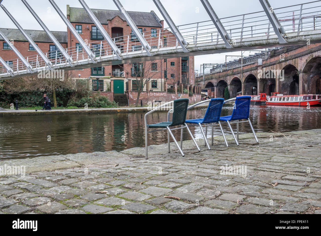 3 empty chairs along the Rochdale canal at Castlefield Manchester Stock Photo