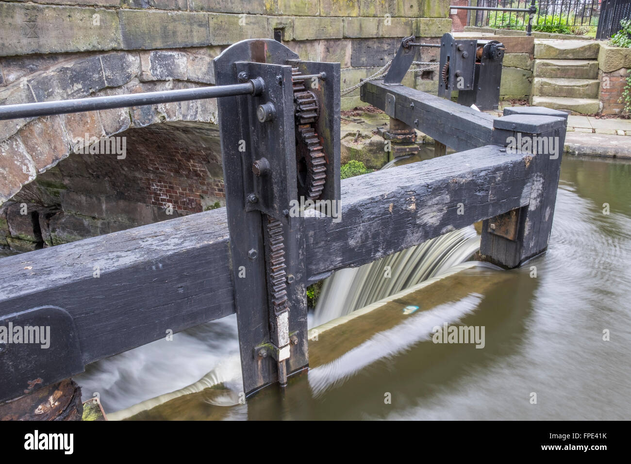 Looking over the lock gates with an overflow of water running over the