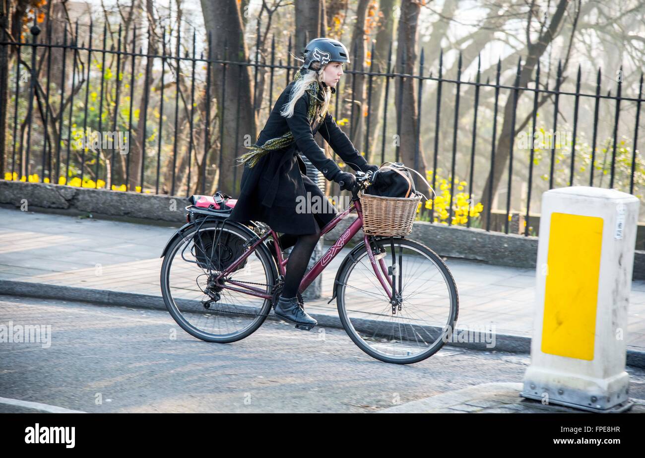Woman commuter riding sit up and beg bike basket Stock Photo