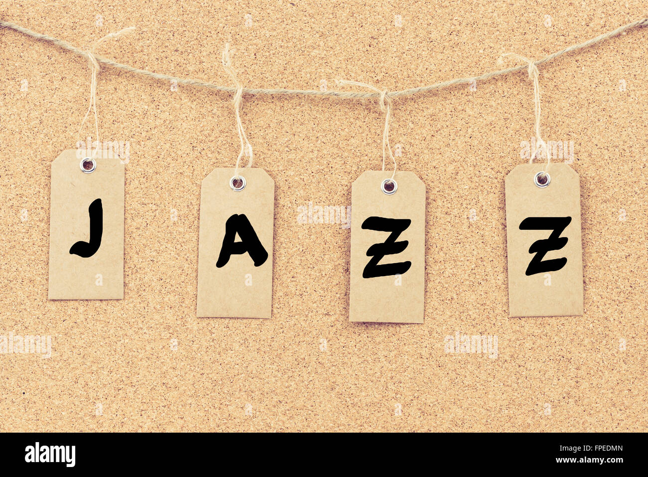 Vintage grunge tags with letters on rope string, word JAZZ over cork ...