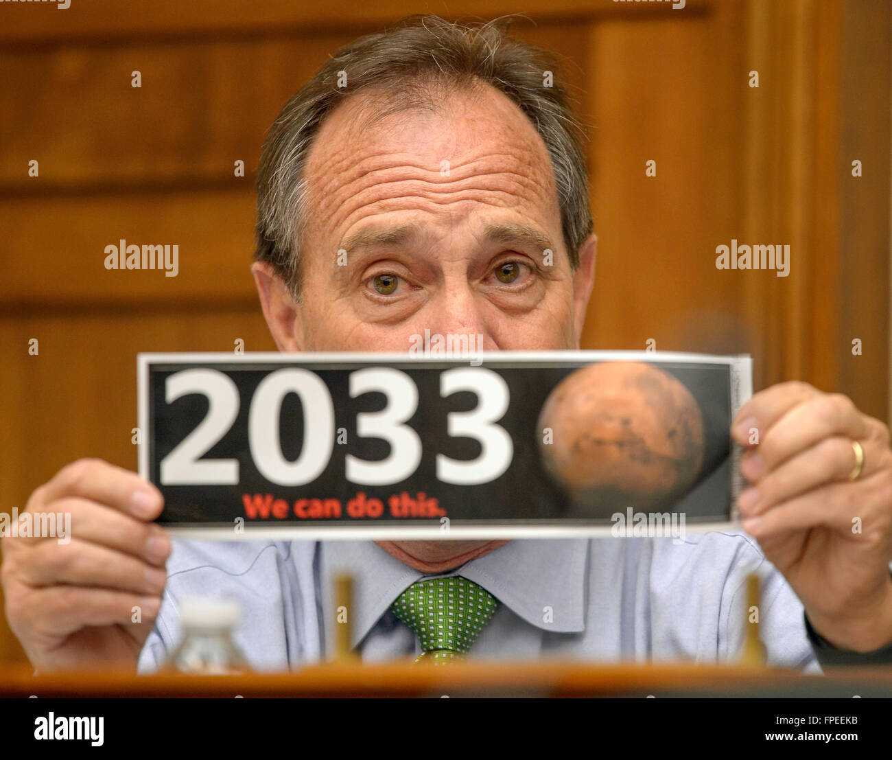 U.S Congressman Ed Perlmutter of Colorado holds up a bumper sticker supporting human missions to mars during the House Committee on Science, Space, and Technology hearing on the budget for the National Aeronautics and Space Administration at the Rayburn House Office Building on Capitol Hill March 17, 2016 in Washington, DC. Stock Photo