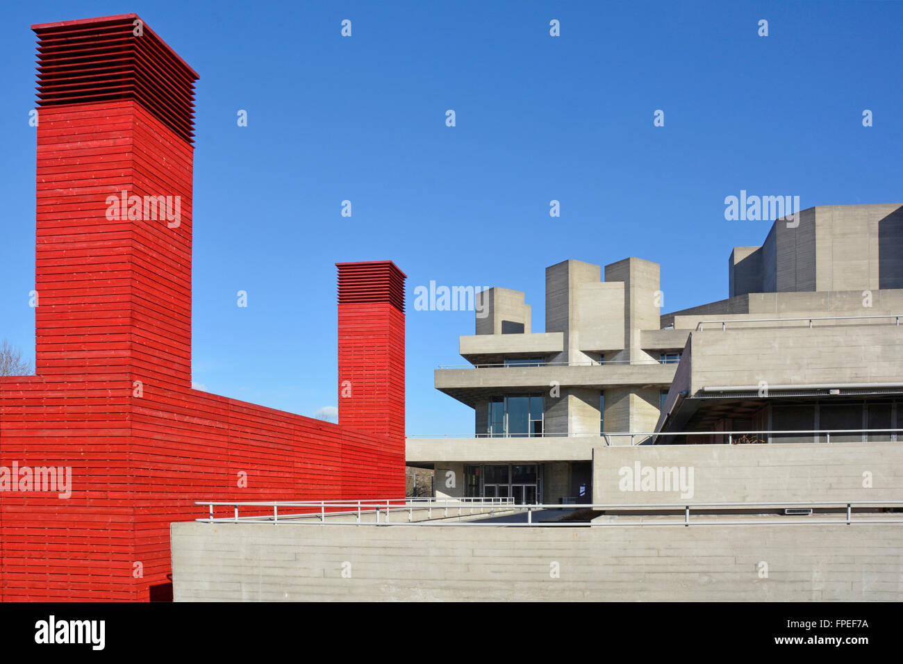 Red Shed temporary Theatre contrasted with the board finish brutalist concrete architecture of original National Theatre South Bank Lambeth London UK Stock Photo