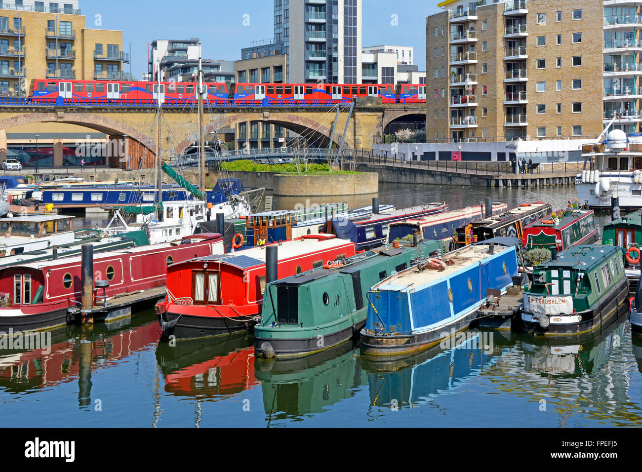 Limehouse Basin Grand Union Canal block of waterside apartments  narrowboat mooring london docklands light railway train Tower Hamlets East London UK Stock Photo