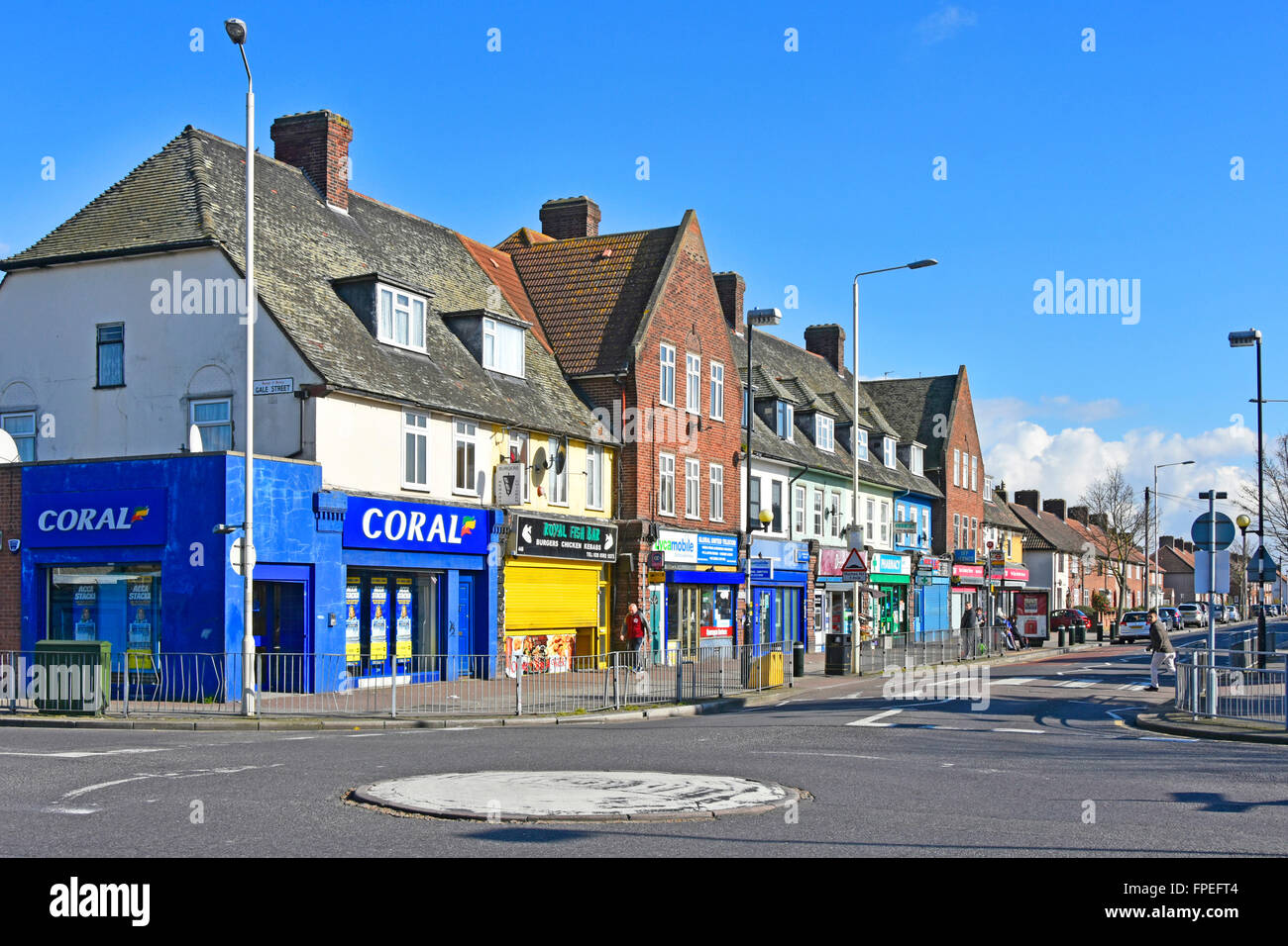 Shopping parade on LCC Becontree housing estate flats above & Coral