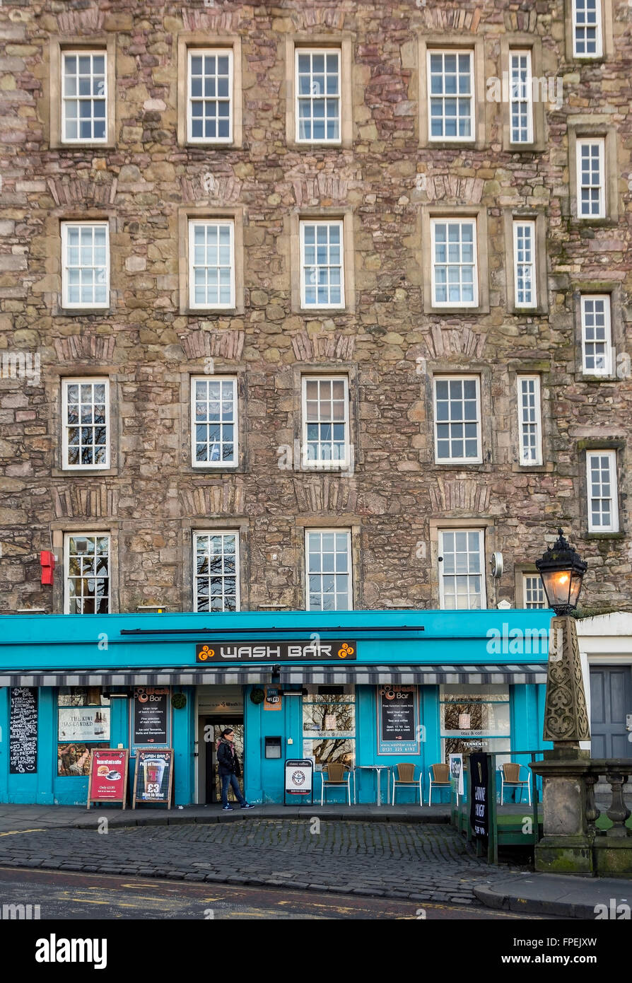 Beneath these old town apartments is one of Edinburgh's many pubs - the Wash bar is on the Mound, overlooking Princes Street. Stock Photo