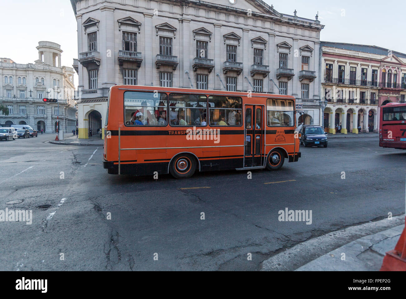HAVANA, CUBA - APRIL 2, 2012: Orange school bus in front of Capitolio Stock Photo