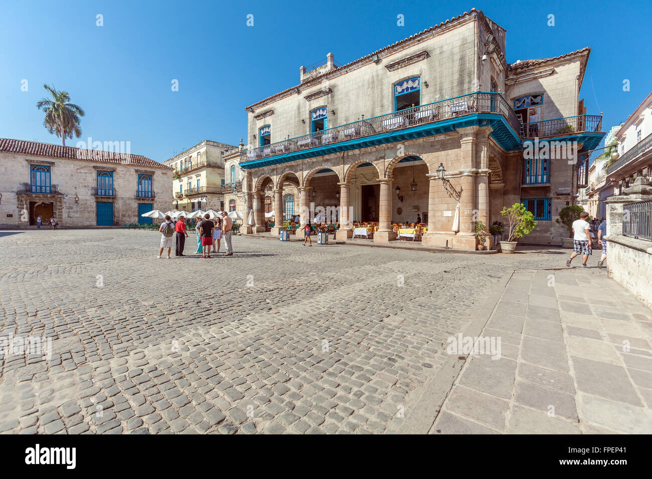 HAVANA, CUBA - APRIL 2, 2012: Tourist walking near El Patio Restaurant in the Cathedral Square Stock Photo