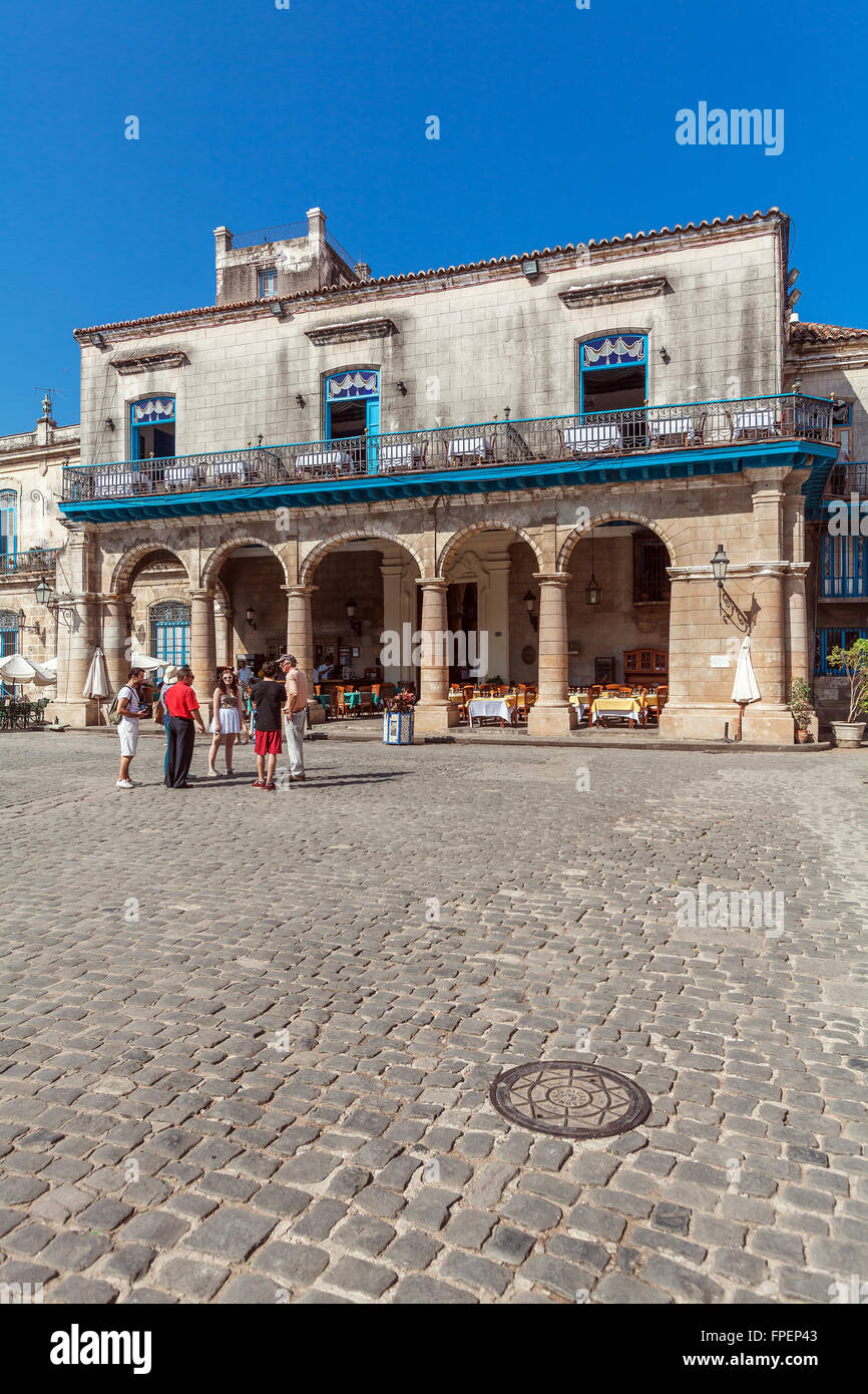 HAVANA, CUBA - APRIL 2, 2012: Tourist walking near El Patio Restaurant in the Cathedral Square Stock Photo
