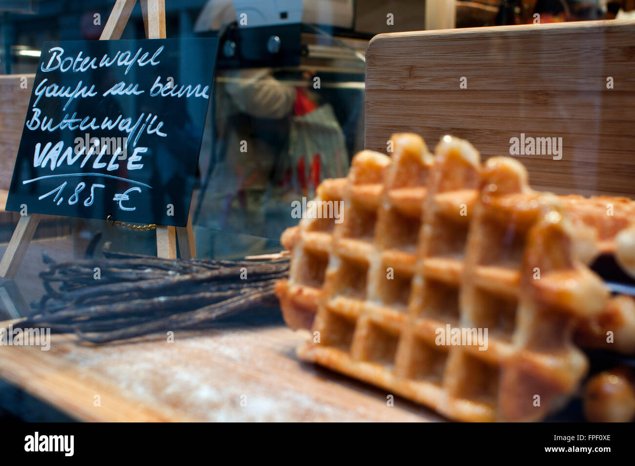 A showcase of a bakery with vanille wafles advertisement, Brussels, Belgium. Another Belgian waffles are typical sweets. There a Stock Photo