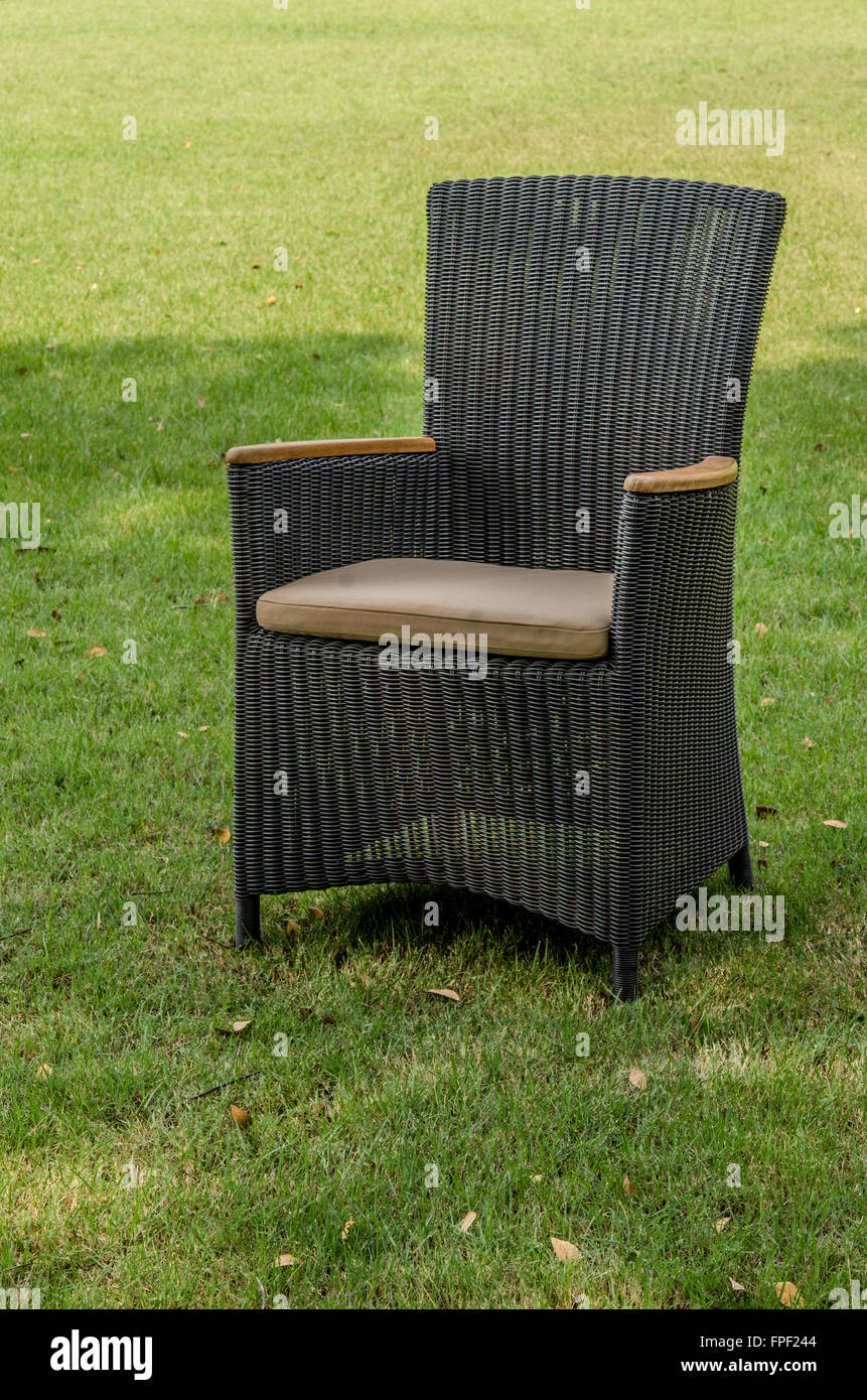 Brown water resistant rattan chair in the garden Stock Photo