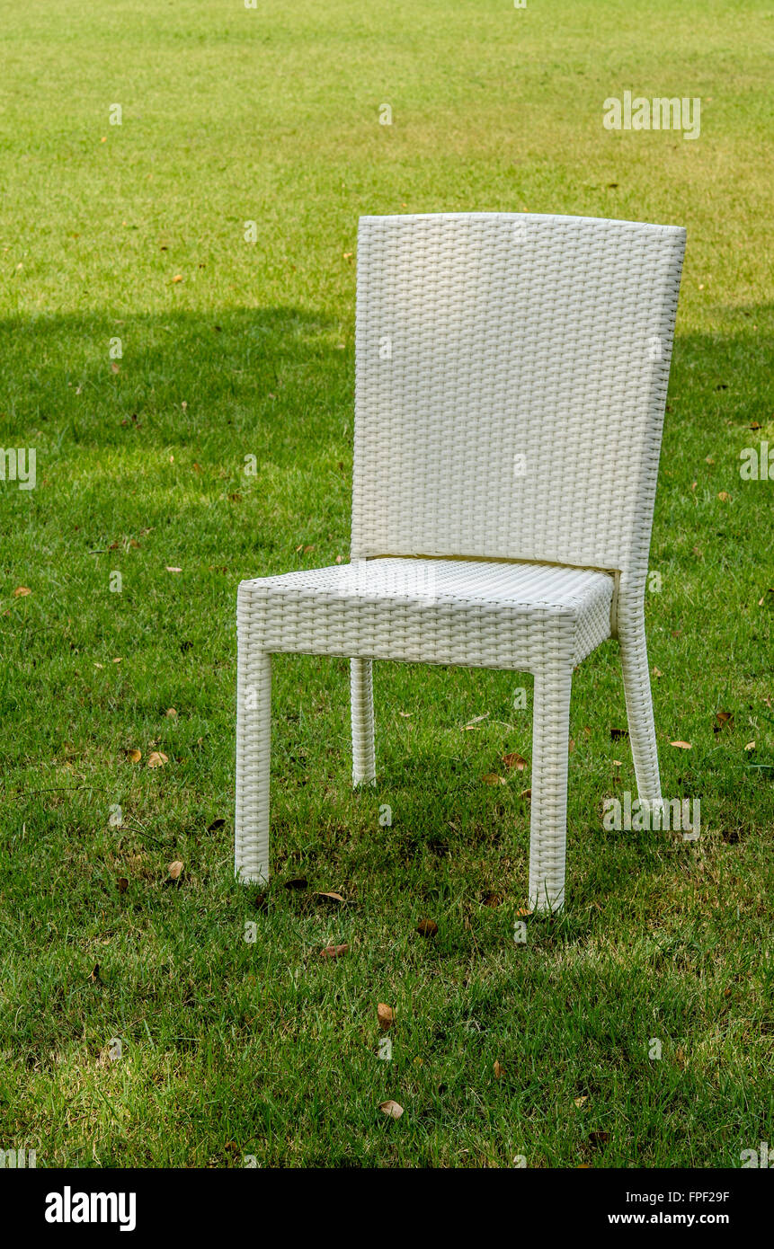 White water resistant rattan chair with cushion in the garden Stock Photo