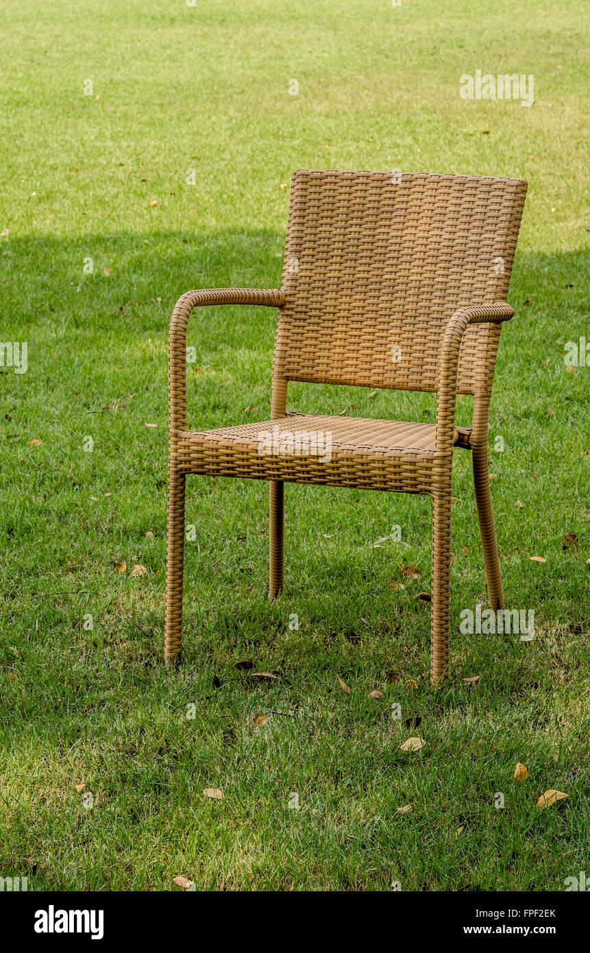 Grey water resistant rattan chair in the garden Stock Photo