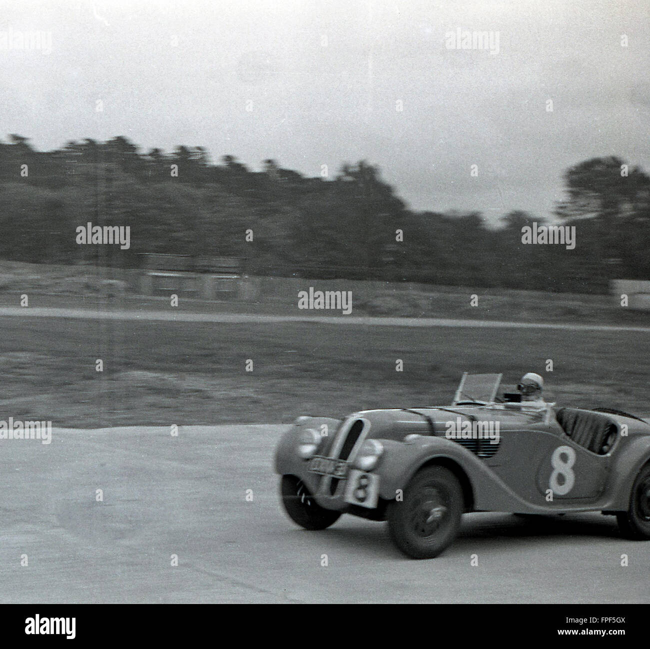 1930s historical, an open top two-seater motor racing car of the era on the Brooklands race track, Weybridge, Surrey. Opened in 1907, the circuit is considered the birthplace of British motorsport. Stock Photo