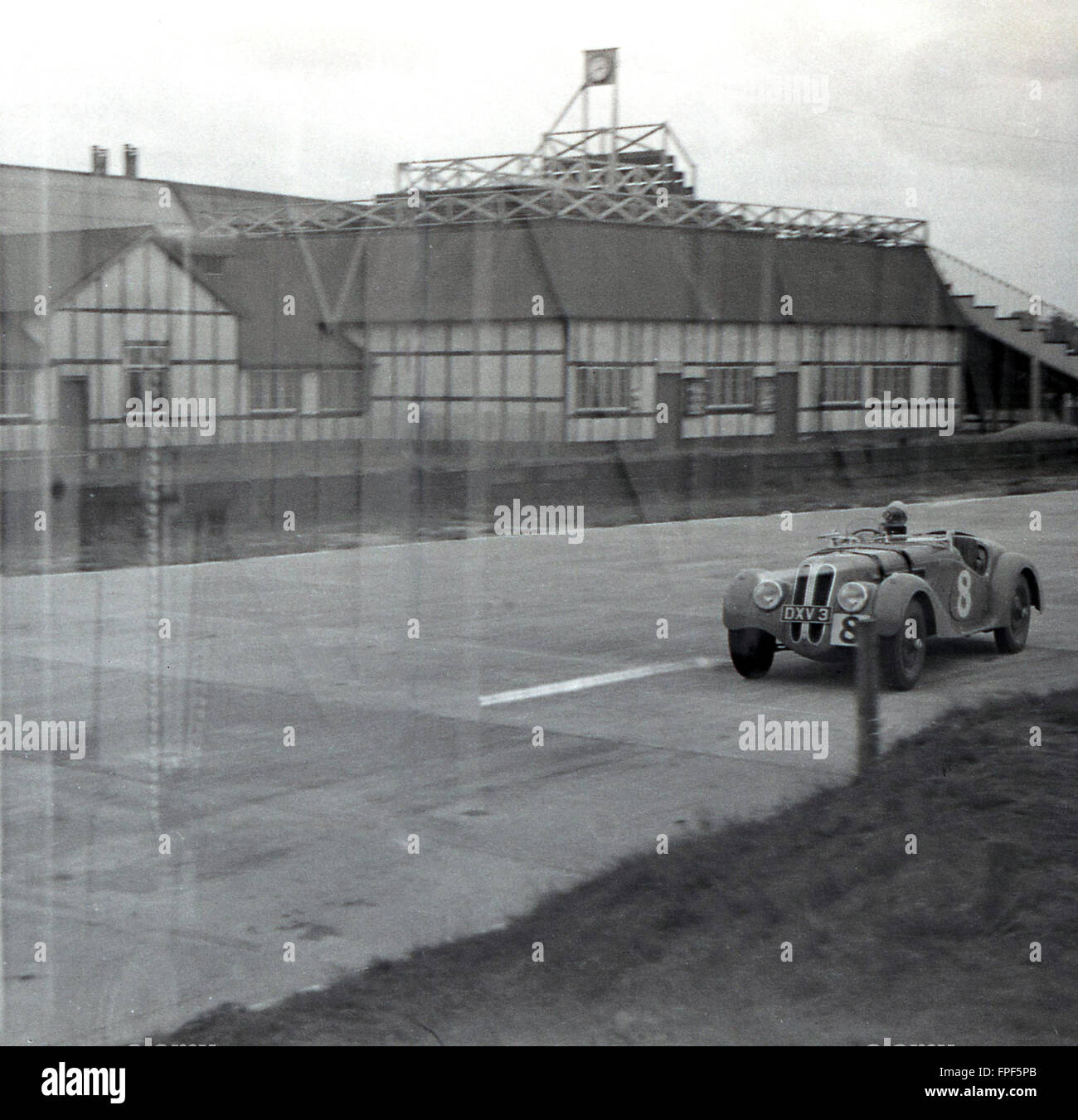 1930s historical, an open top motor racing car of the era going around the Brooklands race track, Weybridge, Surrey. Opened in 1907, the circuit at Brooklands is the birthplace of British motorsport. Stock Photo