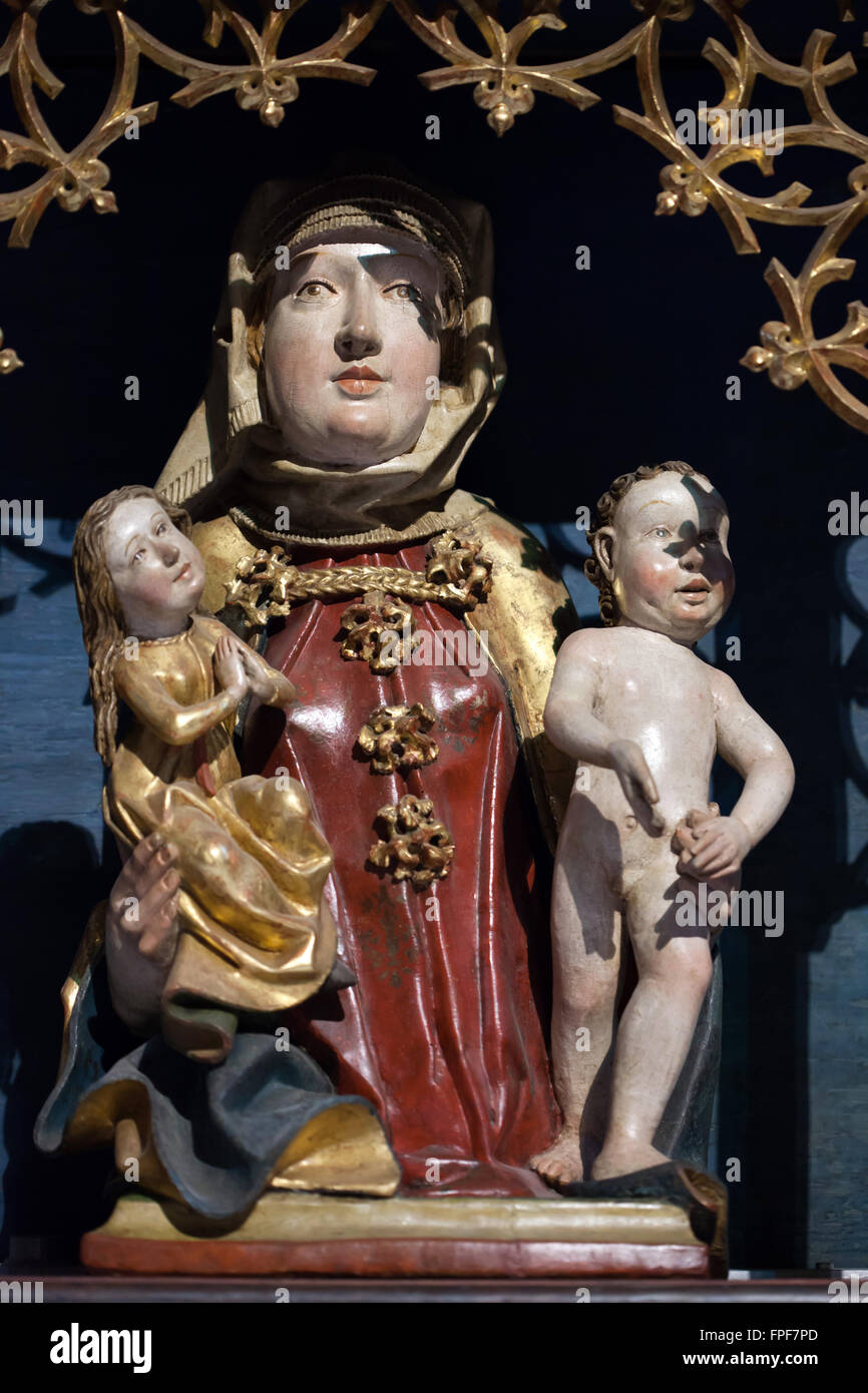 Saint Anna with Virgin Mary and Jesus Christ. Wooden statue from the second part of the 15th century in the predella of the main altar in the Herrgottskirche Church near Creglingen, Baden-Wurttemberg, Germany. Stock Photo