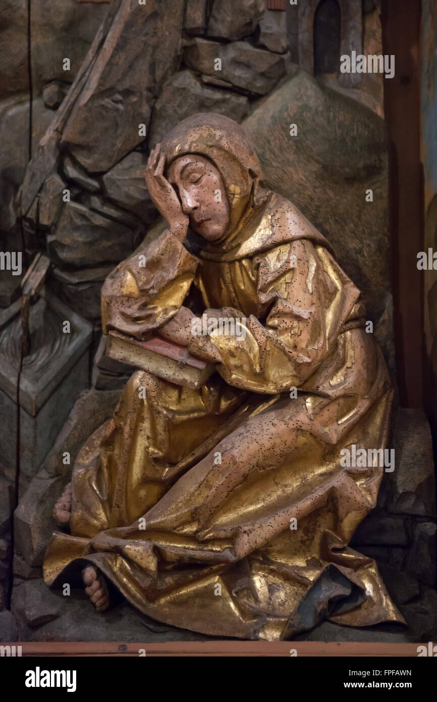 Brother Leo dozing while Saint Francis of Assisi receiving the Stigmata. Detail of the central panel of the Saint Francis Altarpiece by German sculptor Tilman Riemenschneider in the Franciscan Church in Rothenburg ob der Tauber, Middle Franconia, Bavaria, Germany. Stock Photo