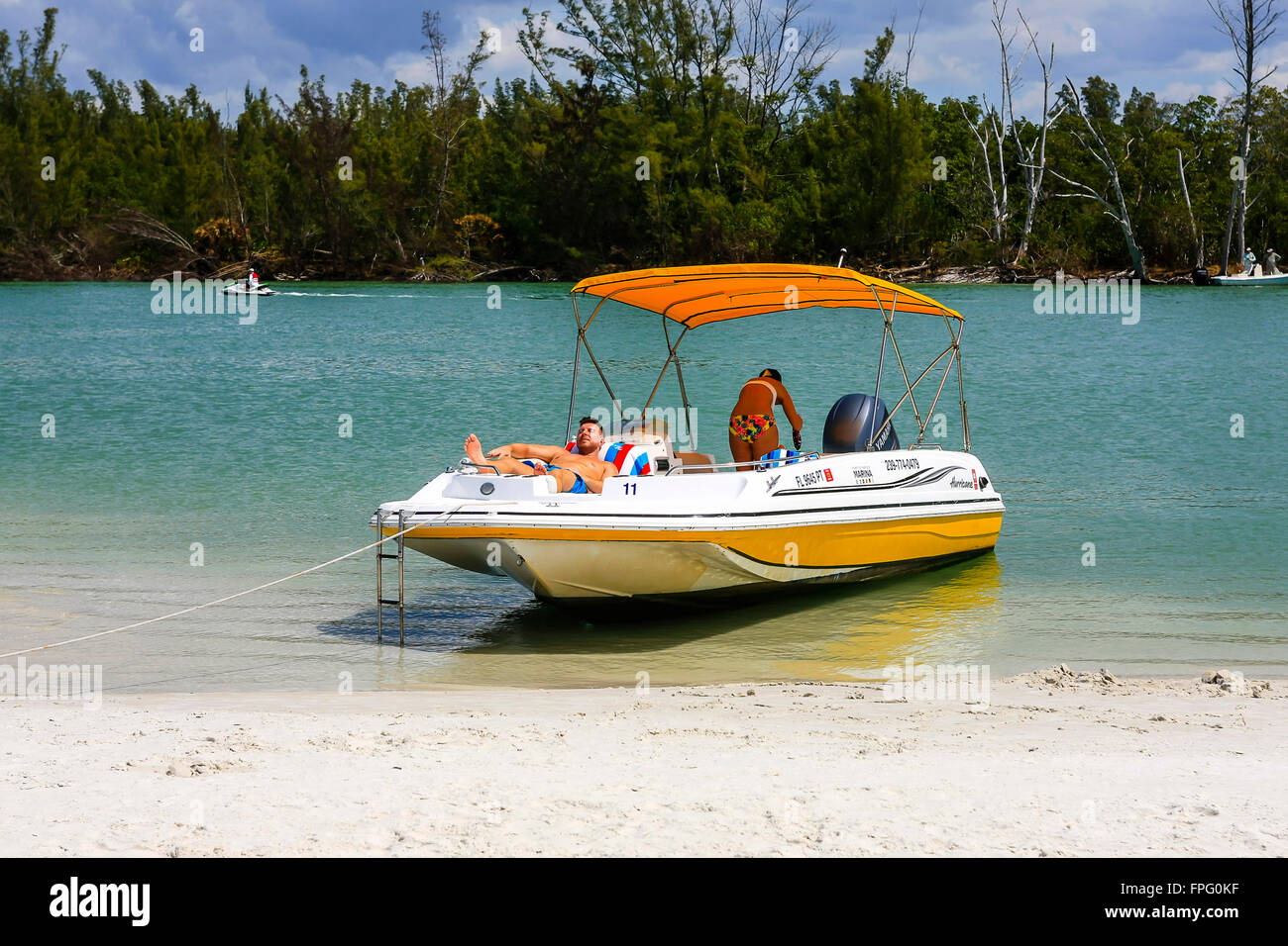 People and their boat having fun in the sun around Keewaydin Island