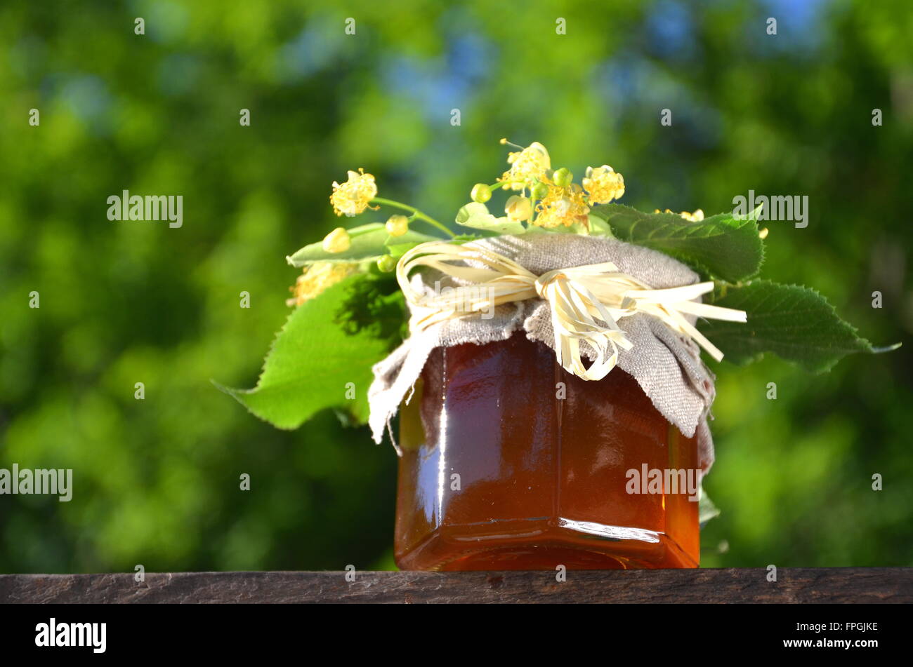 jars of fresh and delicious honey with linden flowers and Stock Photo Alamy