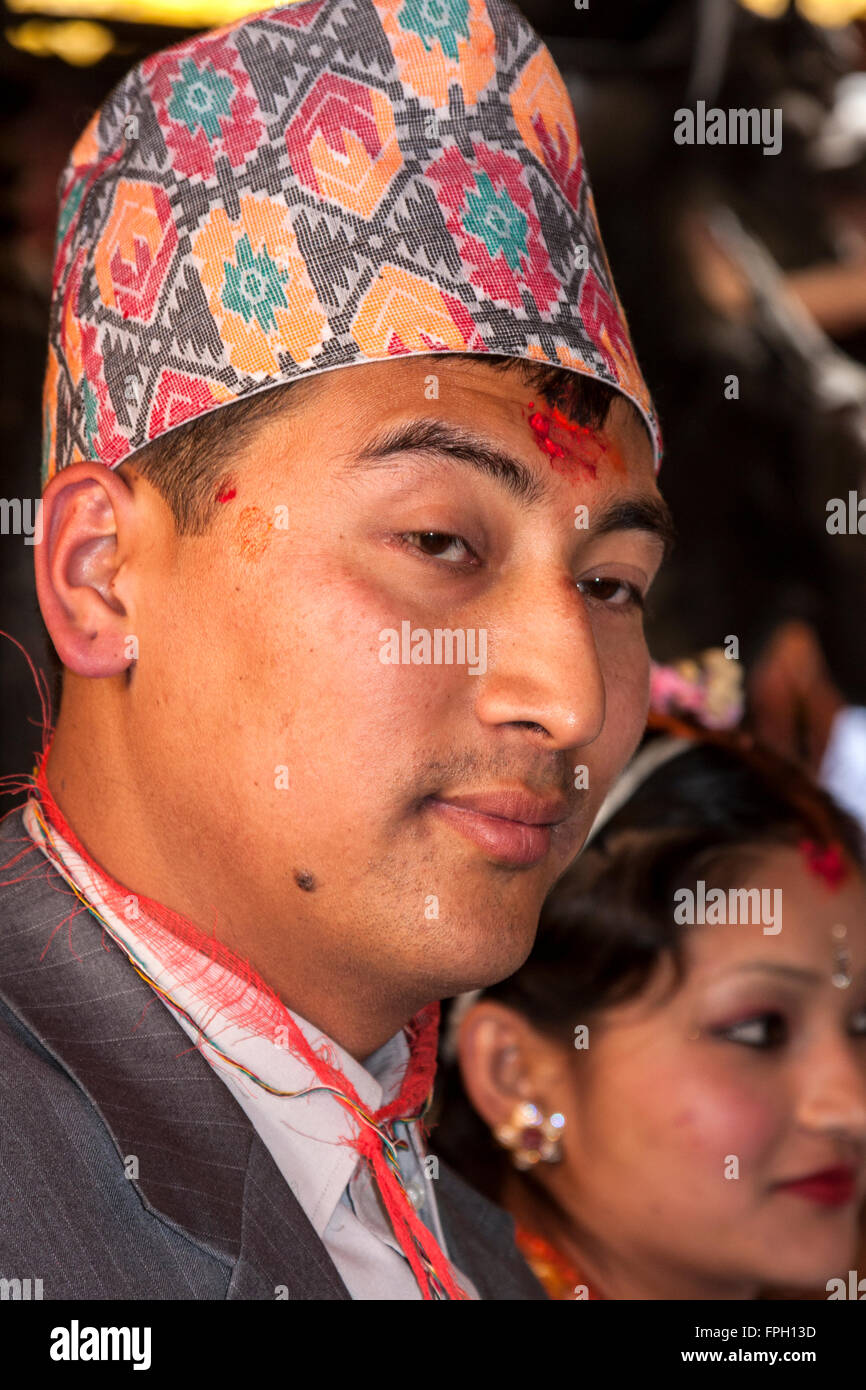 Nepal, Patan. Groom at Wedding Ceremony in Golden Temple, wearing dhaka topi (traditional Nepalese hat) and a  tika on forehead. Stock Photo
