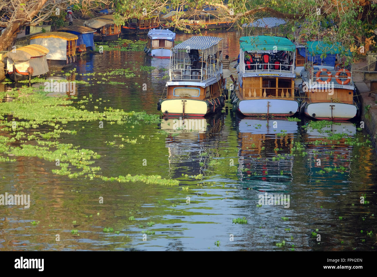Tourist boats on a canal in the town of Aleppey (Alappuzha) in Kerala, India Stock Photo