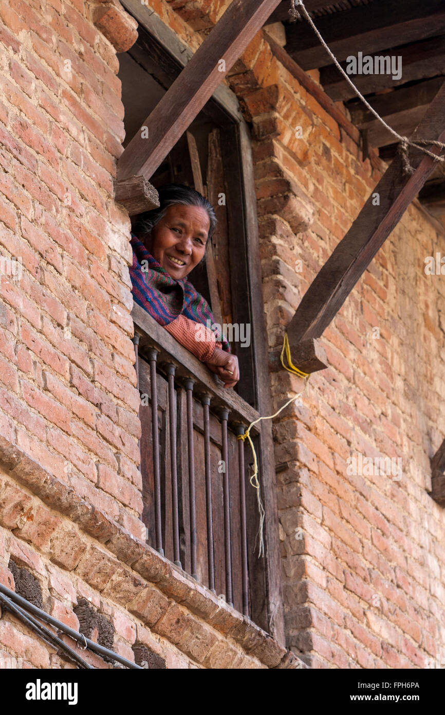 Nepal, Patan.  Woman Looking out of her Window. Stock Photo