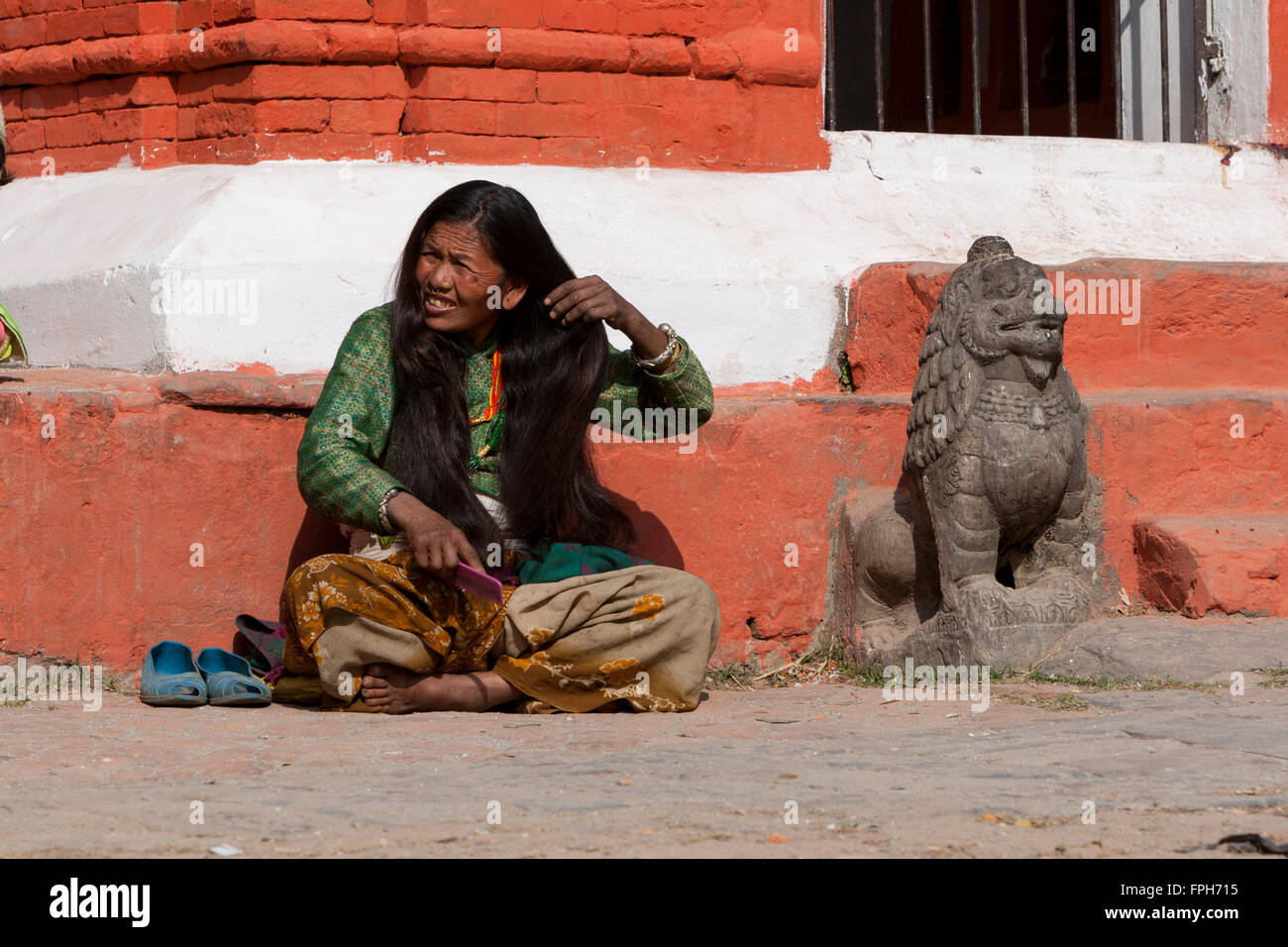 Nepal, Patan.  Woman Combing her Very Long Hair. Stock Photo