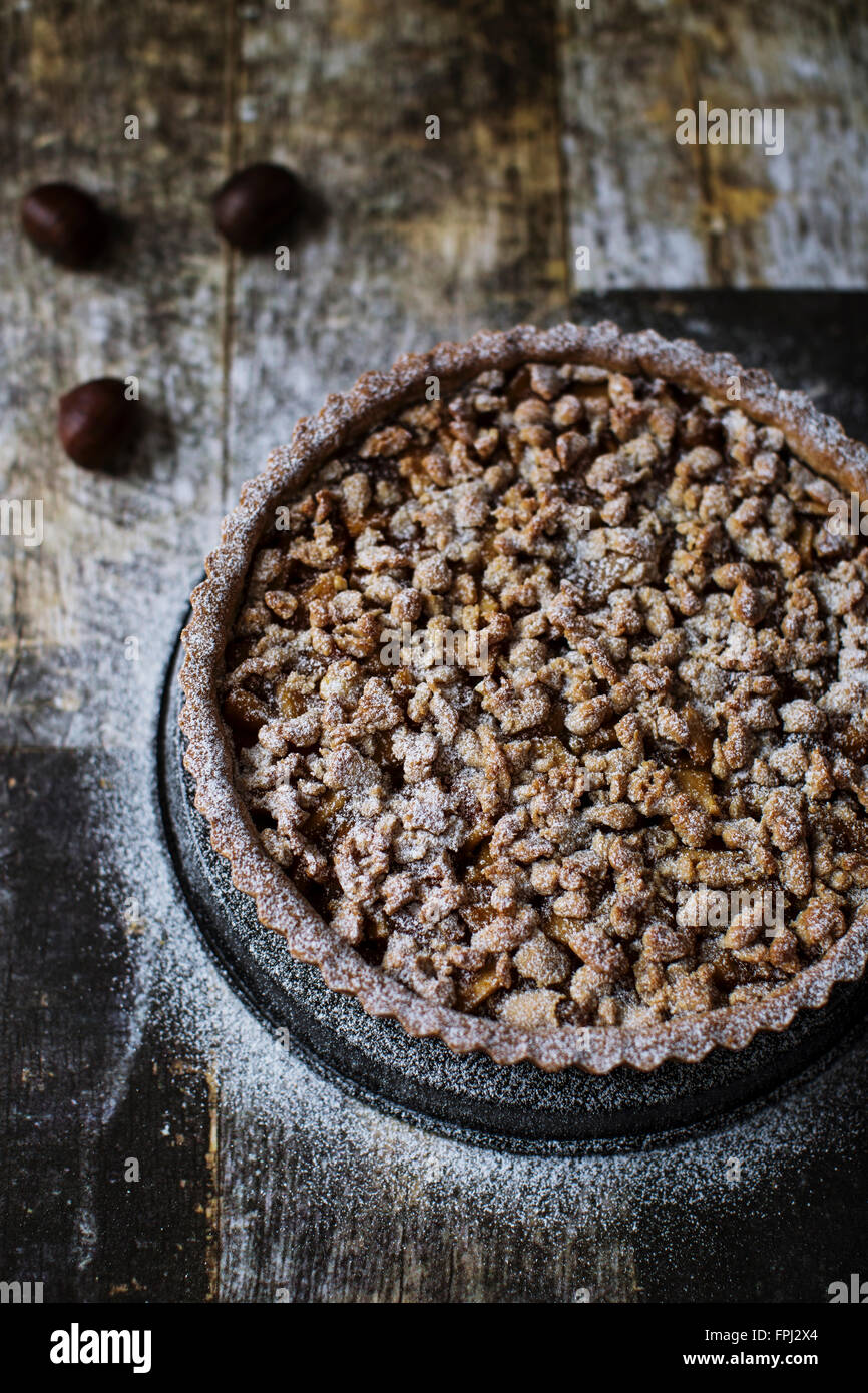 Gluten free tart with chestnut eggless crust, filled with marmelade, candied apples and walnuts Stock Photo