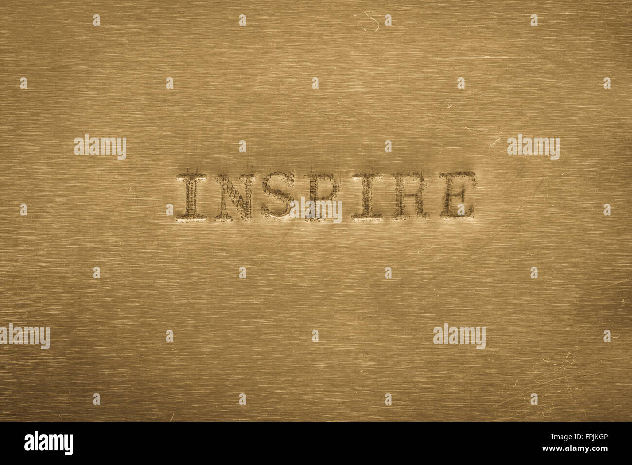 word inspire printed on golden metallic background Stock Photo