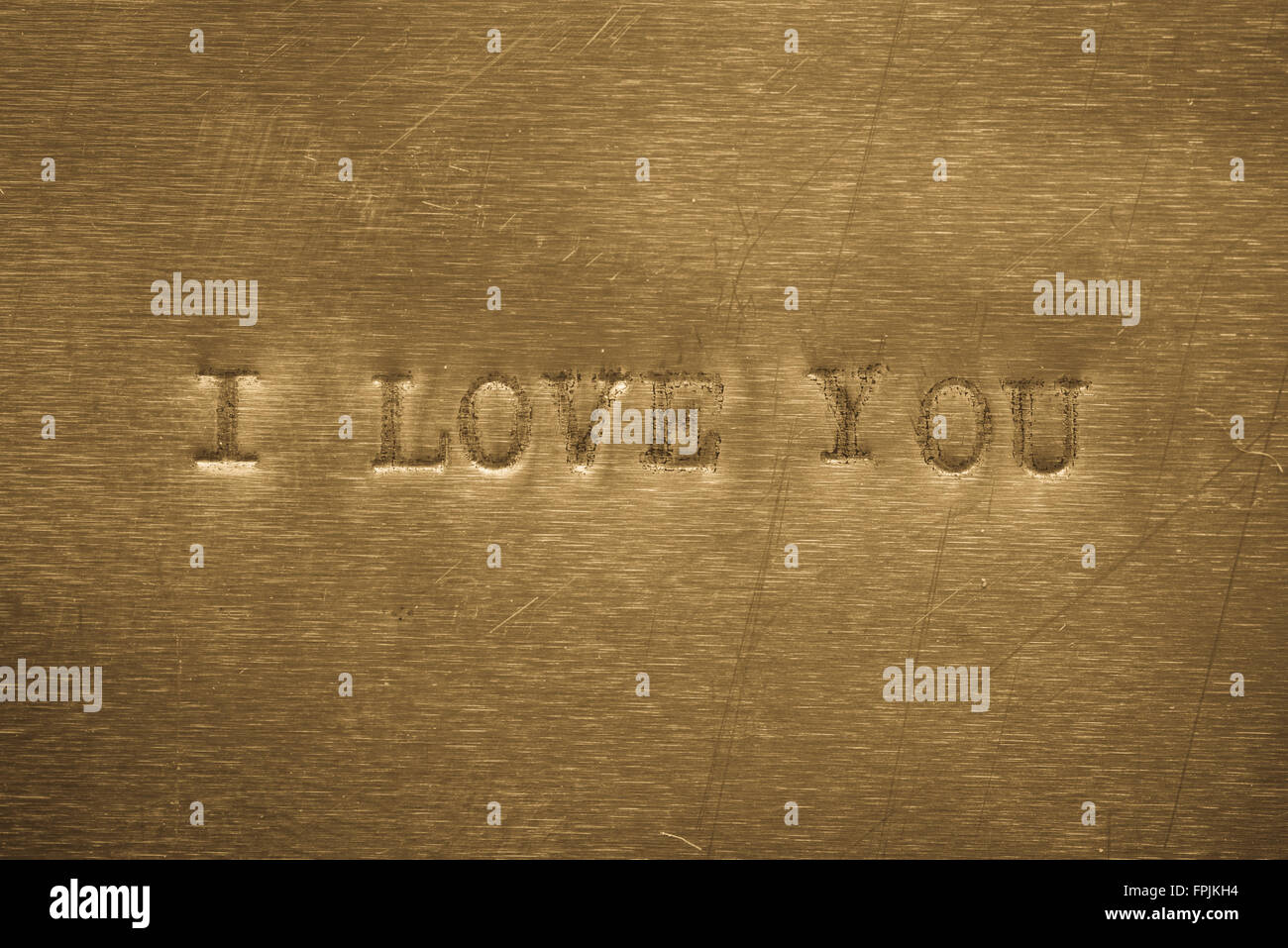 word I love you printed on golden metallic background Stock Photo