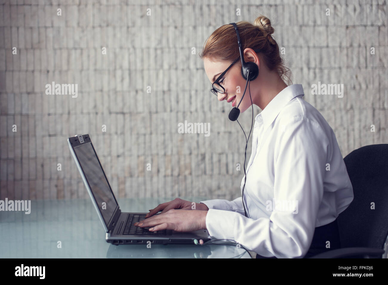 Young casual woman customer support in office Stock Photo