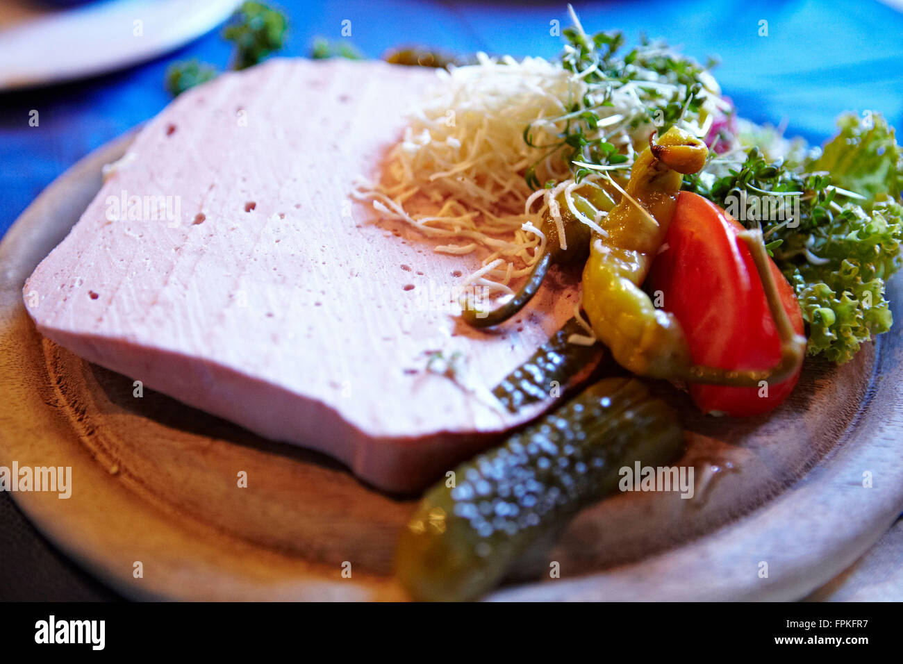 Bavarian snack, Leberkäse with garnish Stock Photo