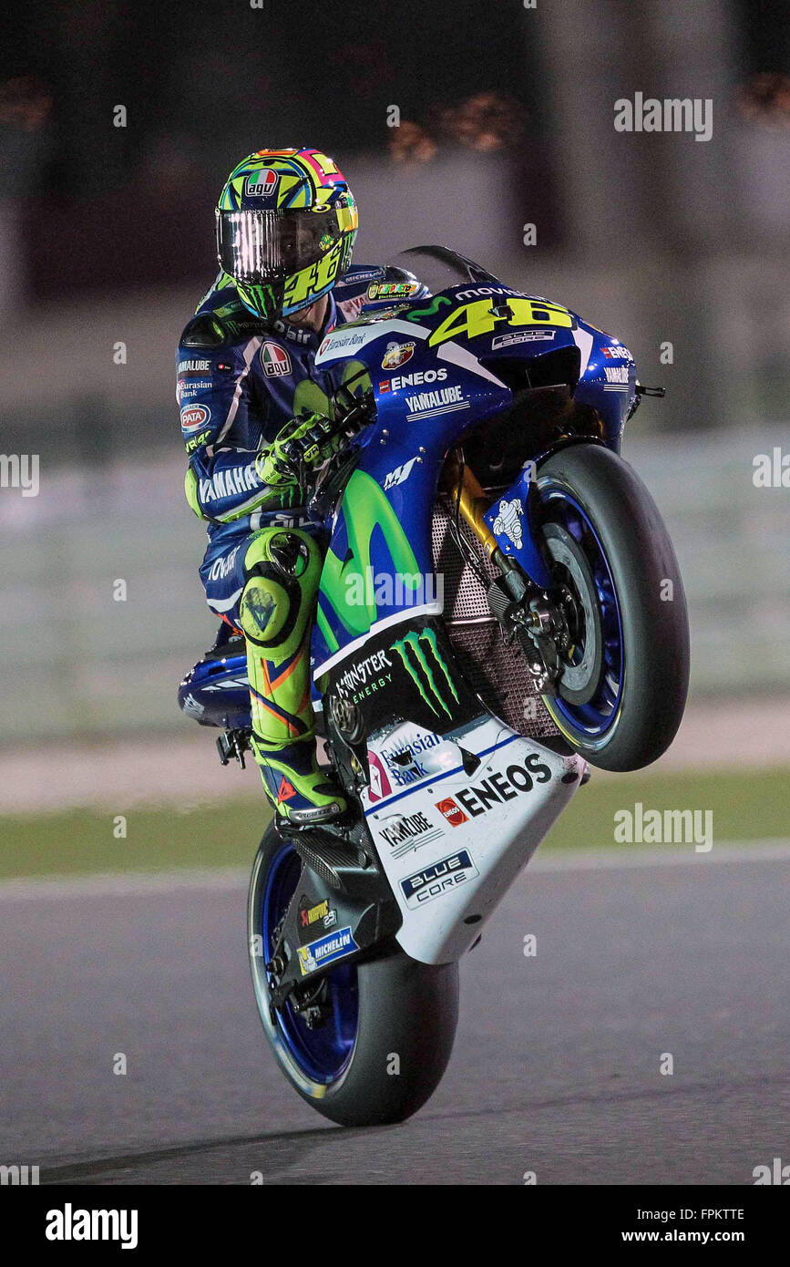 Doha, Qatar. 18th March, 2016. Valentino Rossi of Italy and Yamaha Factory  Racing performs a wheelie during MotoGP of Qatar - at Losail Circuit on  March 18, 2016 in Doha, Qatar. (Photo