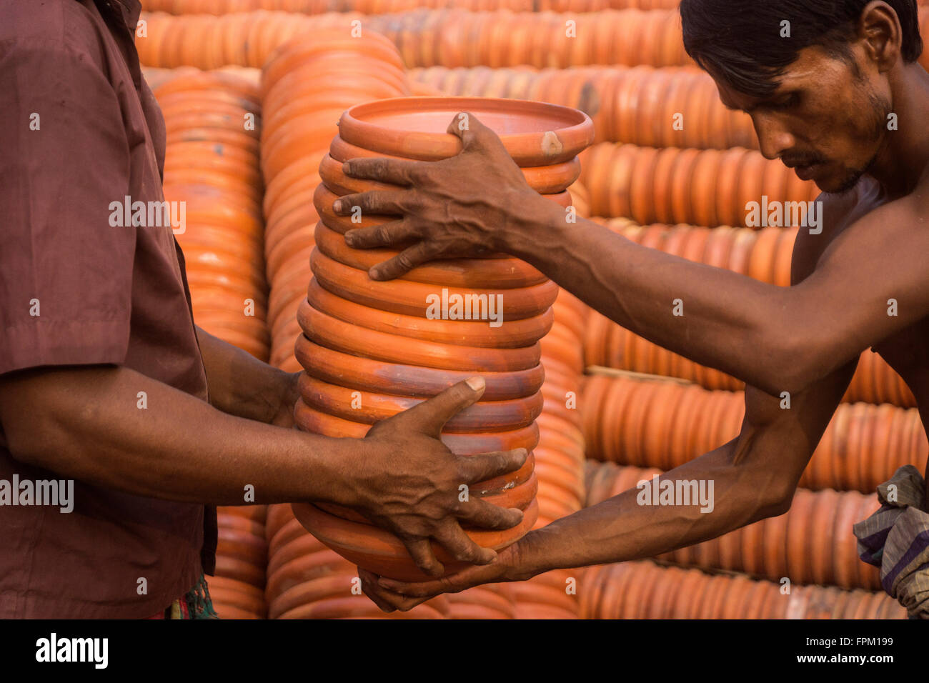 Dhaka, Bangladesh. 19th Mar, 2016. Workers are delivering clay plate to