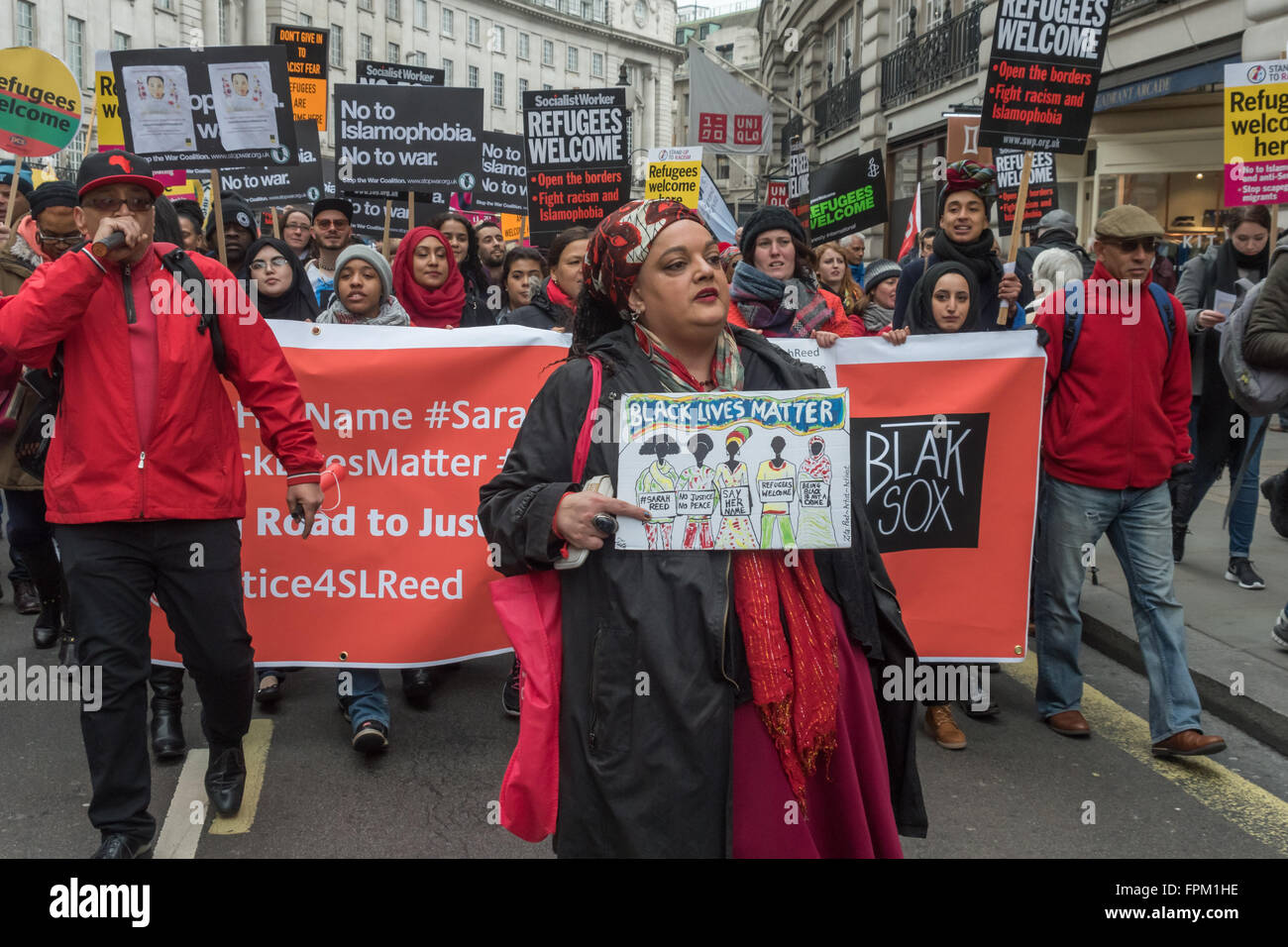 London, UK. Saturday 19th March 2016. Zita Holbourne and Lee Jasper (left) walk in front of the BlakSox banner and the 'Black Lives Matter' Bloc as thousands march through London from the BBC in a national demonstration organised by Stand Up to Racism against racism, Islamophobia, anti-Semitism and fascism and to say clearly that refugees are welcome here. Peter Marshall/Alamy Live News Stock Photo