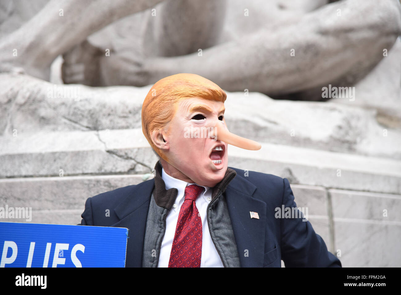 New York, USA, 19 March 2016: activist in long-nose Trump mask horses around in Columbus Circle during NYC rally against Republican front runner Donald Trump Credit:  Andrew Katz/Alamy Live News Stock Photo