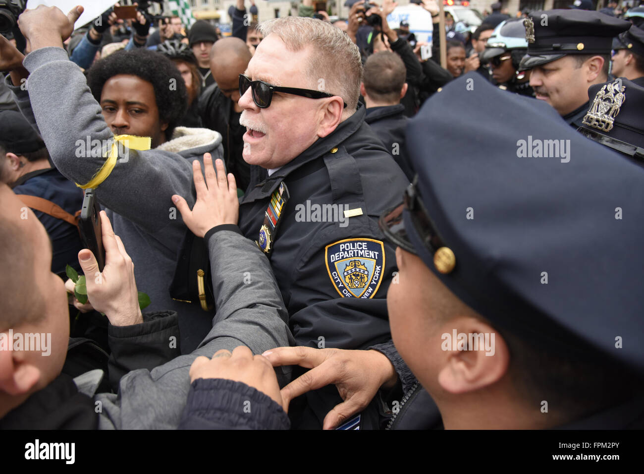 New York, USA, 19 March 2016: marchers grappling with NYPD attempting to cross 59th Street during NYC rally against Republican front runner Donald Trump Credit:  Andrew Katz/Alamy Live News Stock Photo