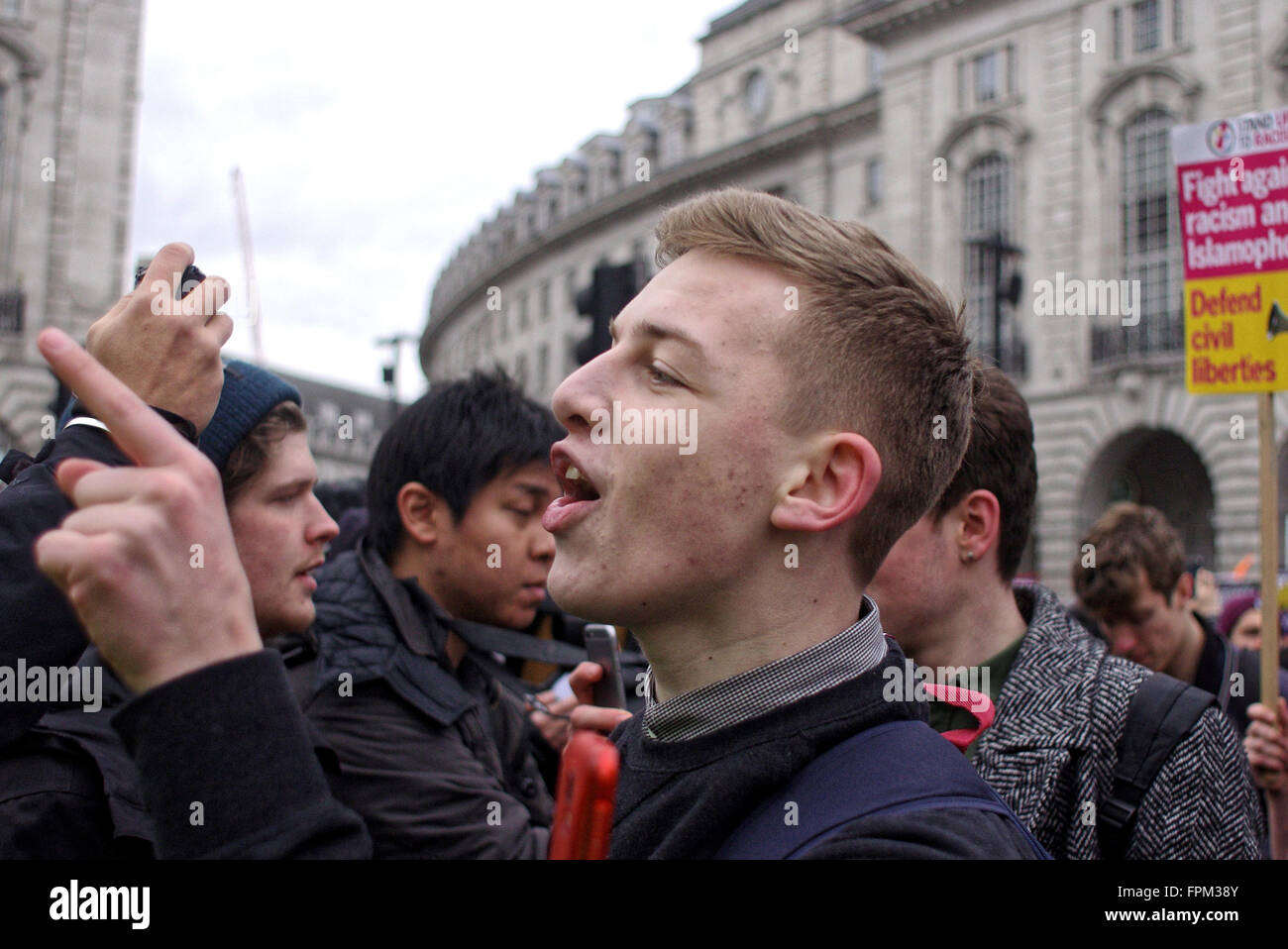 London, UK. Saturday 19th March 2016. A young antifasicist protester remonstrates with the Britain First group  at Piccadilly Circus. Stock Photo