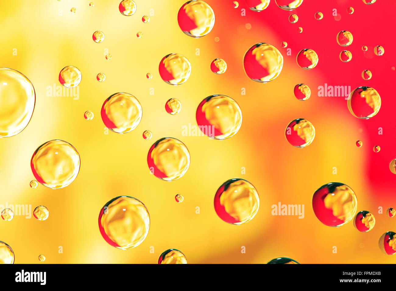 Abstract yellow background with various water drops Stock Photo - Alamy