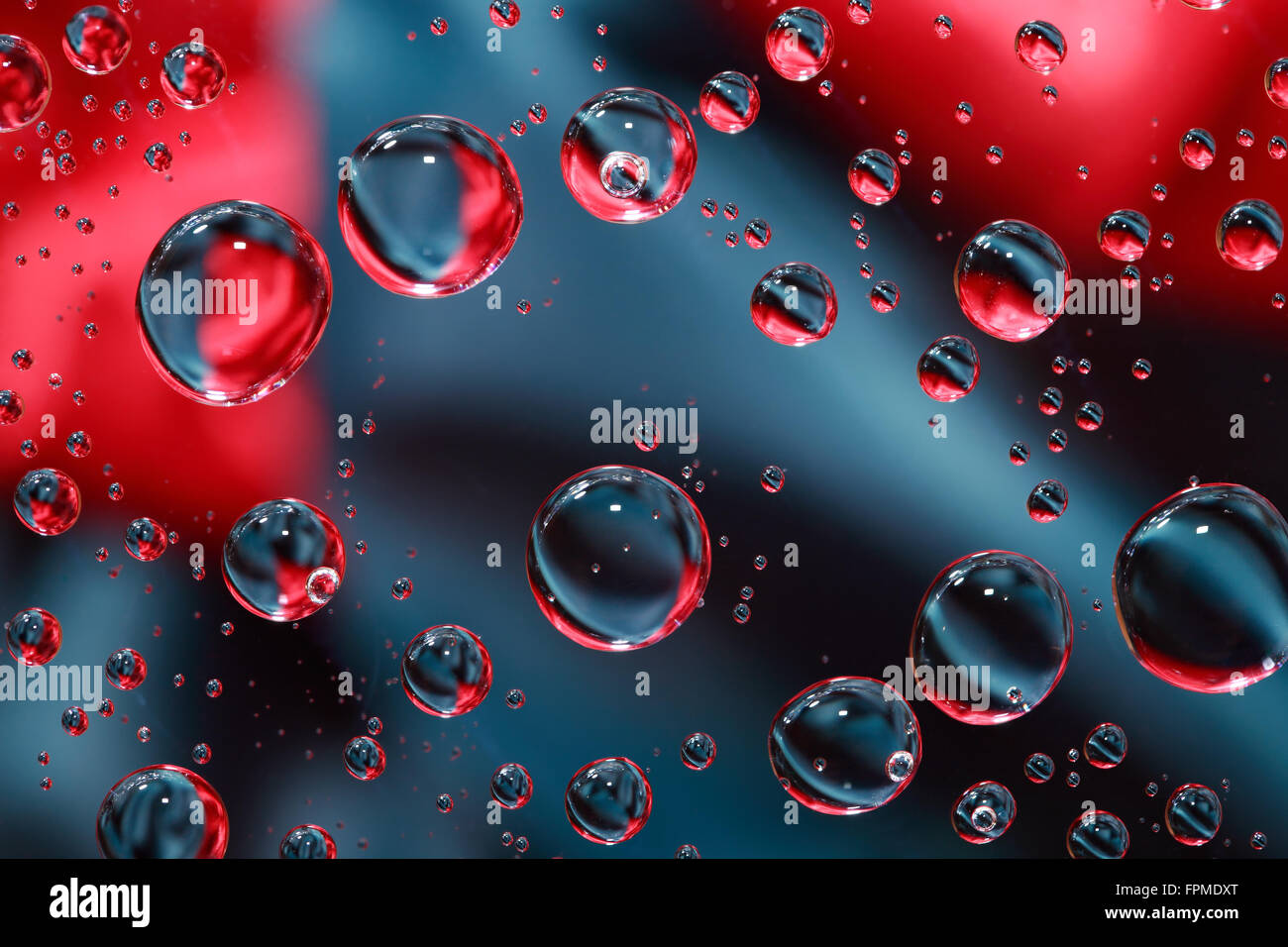 Abstract red and black background with various water drops Stock